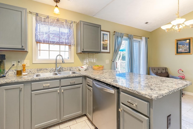 kitchen with a peninsula, dishwasher, a sink, and gray cabinets
