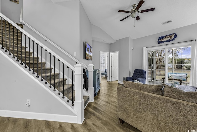 living area with visible vents, ceiling fan, baseboards, stairway, and wood finished floors