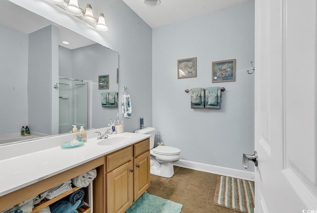 bathroom with tile patterned floors, toilet, a stall shower, baseboards, and vanity