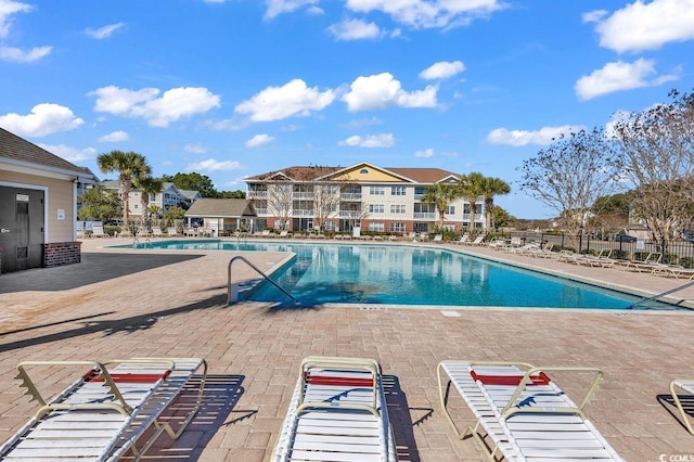 community pool featuring a patio area and fence