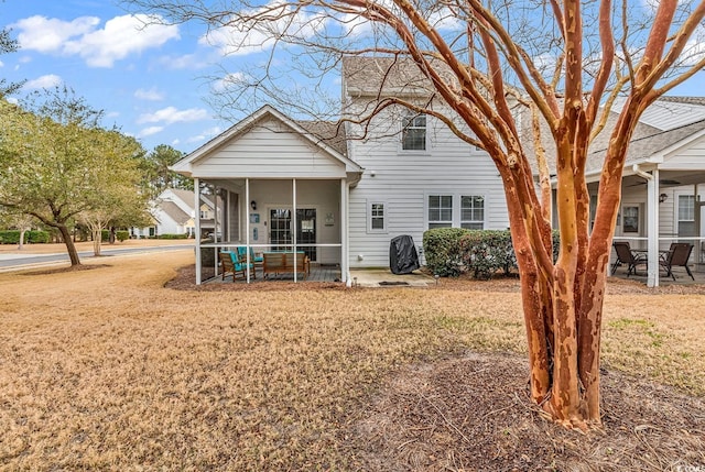 back of house featuring a patio and a sunroom