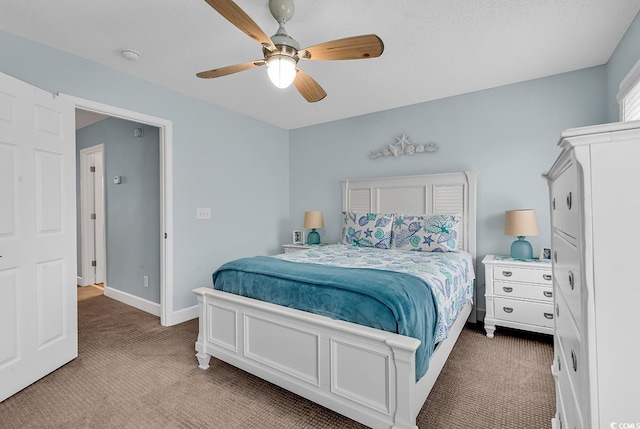 bedroom with light colored carpet, baseboards, and ceiling fan