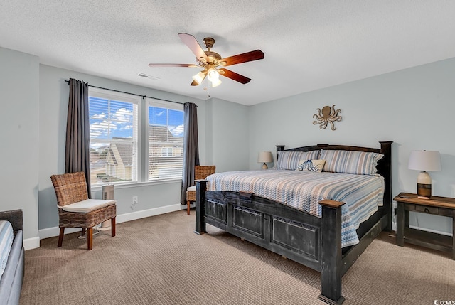 bedroom featuring visible vents, baseboards, ceiling fan, a textured ceiling, and light colored carpet