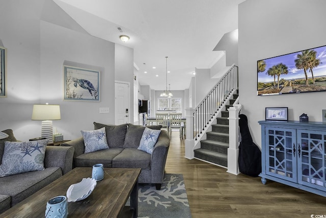 living room with crown molding, stairs, recessed lighting, an inviting chandelier, and wood finished floors