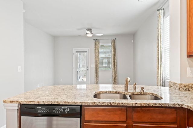 kitchen with a ceiling fan, a sink, brown cabinetry, light stone countertops, and dishwasher