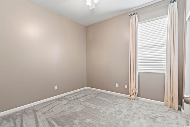 unfurnished room featuring carpet flooring, baseboards, and ceiling fan