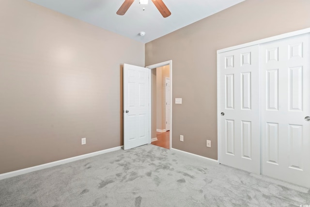 unfurnished bedroom with a closet, baseboards, carpet, and a ceiling fan