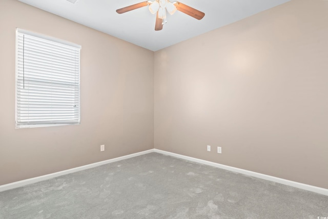 spare room featuring carpet flooring, ceiling fan, and baseboards