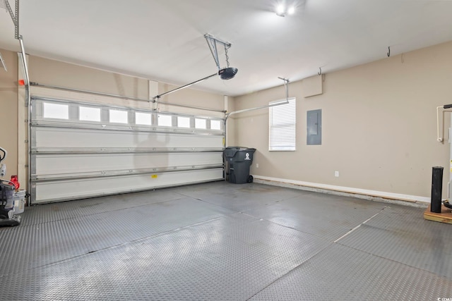 garage featuring electric panel, a garage door opener, and baseboards