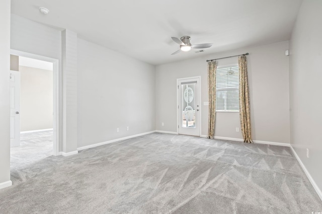 carpeted empty room with baseboards and ceiling fan