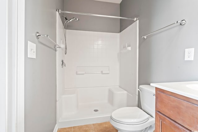 full bath featuring tile patterned flooring, toilet, vanity, and walk in shower