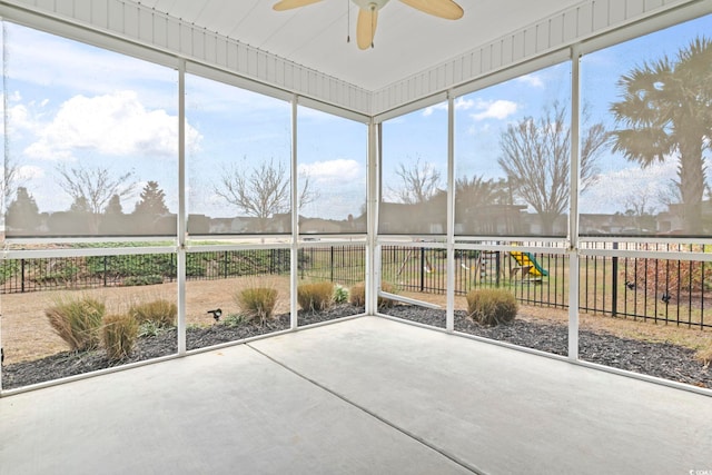 unfurnished sunroom with ceiling fan