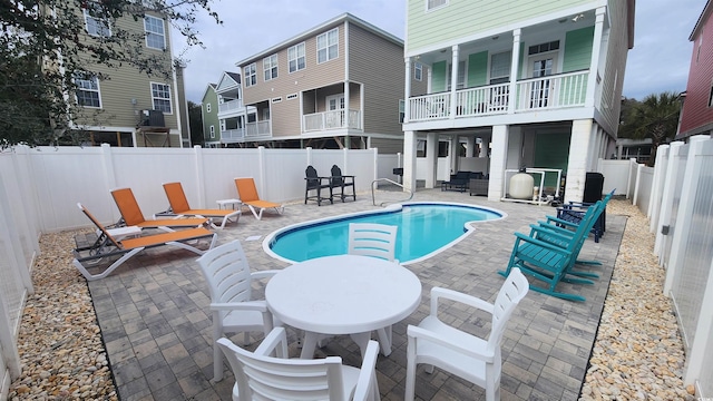 view of pool with a fenced in pool, a fenced backyard, and a patio area