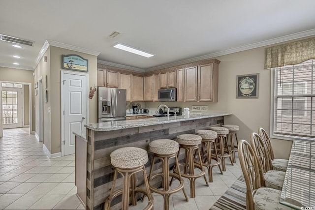 kitchen with a peninsula, light tile patterned floors, visible vents, and stainless steel appliances