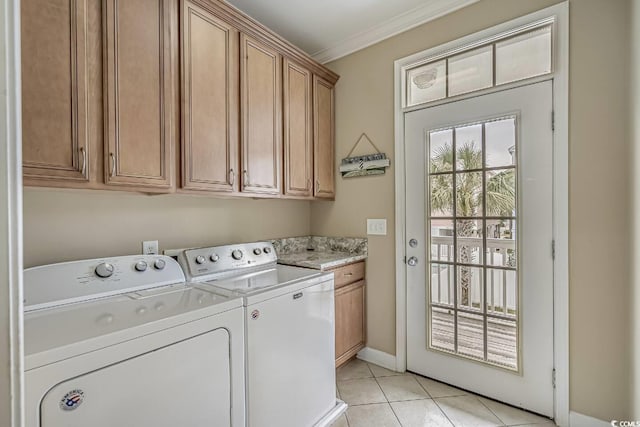 laundry area with baseboards, ornamental molding, light tile patterned flooring, cabinet space, and independent washer and dryer