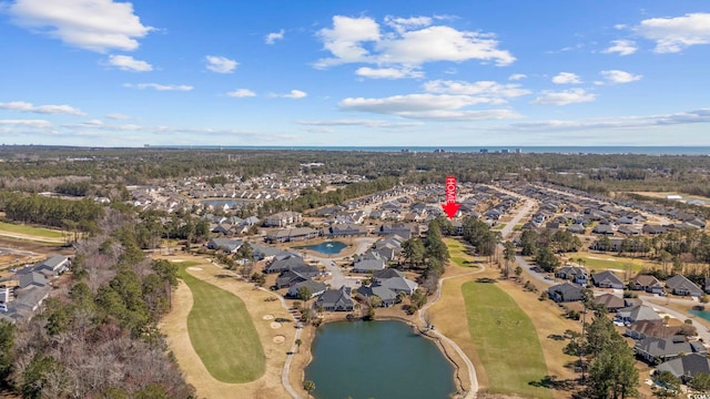 birds eye view of property with a residential view, a water view, and view of golf course