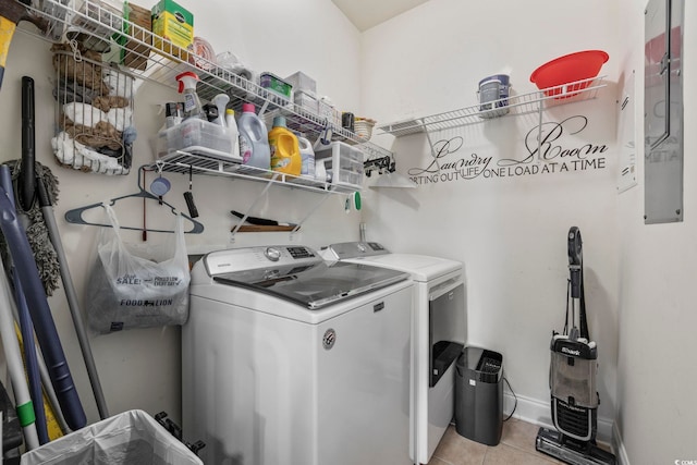 laundry area featuring light tile patterned floors, laundry area, baseboards, and separate washer and dryer