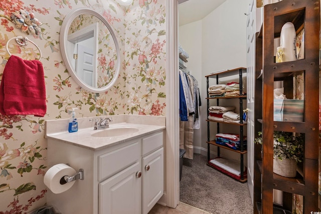 bathroom featuring wallpapered walls and vanity