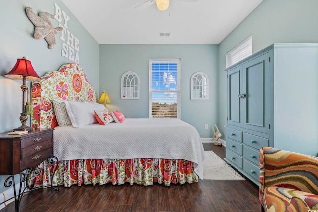 bedroom featuring ceiling fan, visible vents, baseboards, and wood finished floors