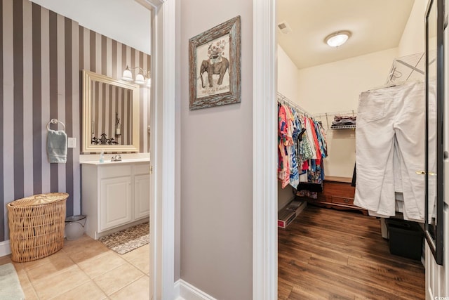 spacious closet featuring visible vents and wood finished floors