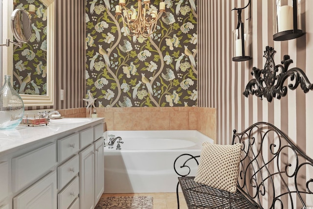 full bath with vanity, a bath, tile patterned flooring, and wallpapered walls