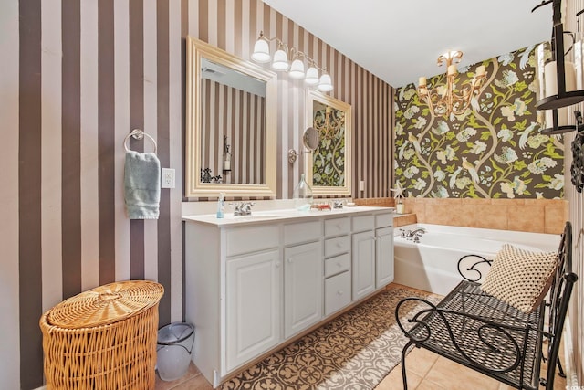 full bath featuring tile patterned flooring, wallpapered walls, a garden tub, double vanity, and a sink