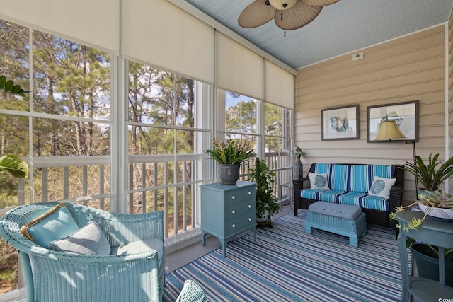 sunroom featuring a ceiling fan