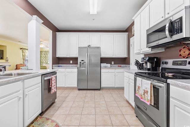 kitchen featuring ceiling fan, light countertops, light tile patterned floors, appliances with stainless steel finishes, and white cabinetry