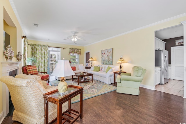 living area with visible vents, light wood-style flooring, a fireplace, and ornamental molding