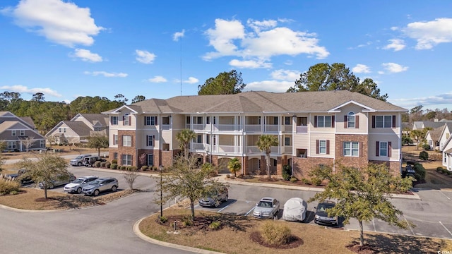 view of building exterior featuring a residential view and uncovered parking