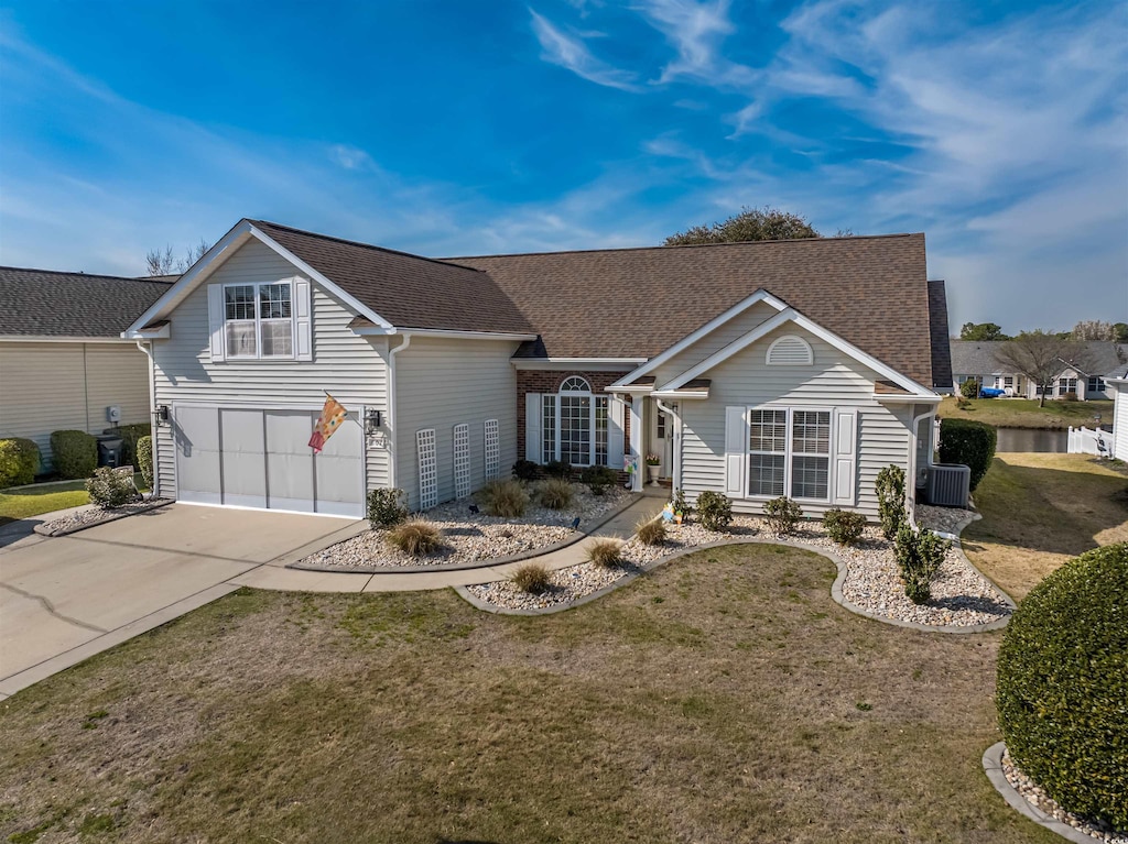 view of front facade featuring central AC unit, driveway, a front yard, and a garage