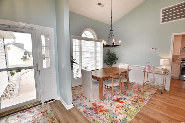 dining room with visible vents, a notable chandelier, and light wood-style flooring