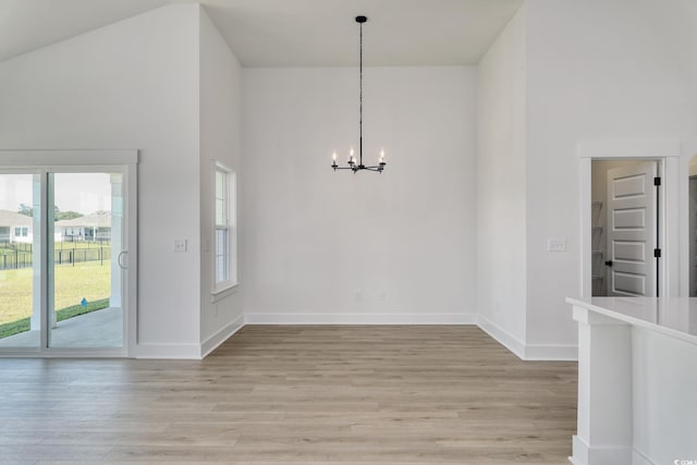 4028 Bucolic Loop, Myrtle Beach, SC 29588 - unfurnished dining area with a chandelier, light wood-style flooring, a towering ceiling, and baseboards