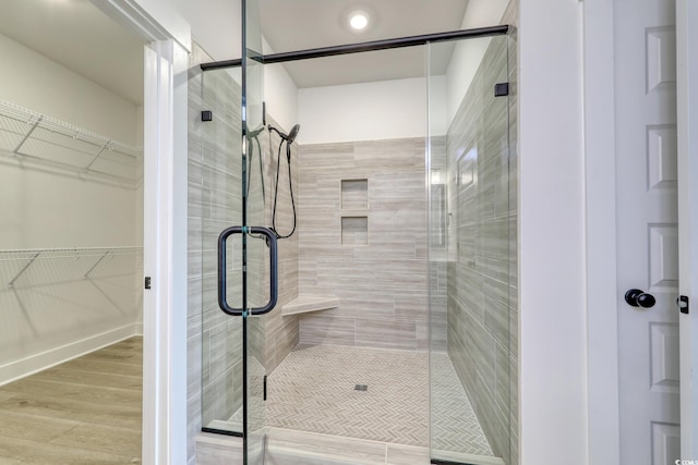 4028 Bucolic Loop, Myrtle Beach, SC 29588 - full bathroom featuring a shower stall, wood finished floors, and a spacious closet