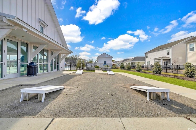 surrounding community with a residential view and fence