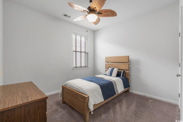 carpeted bedroom with visible vents, baseboards, and ceiling fan