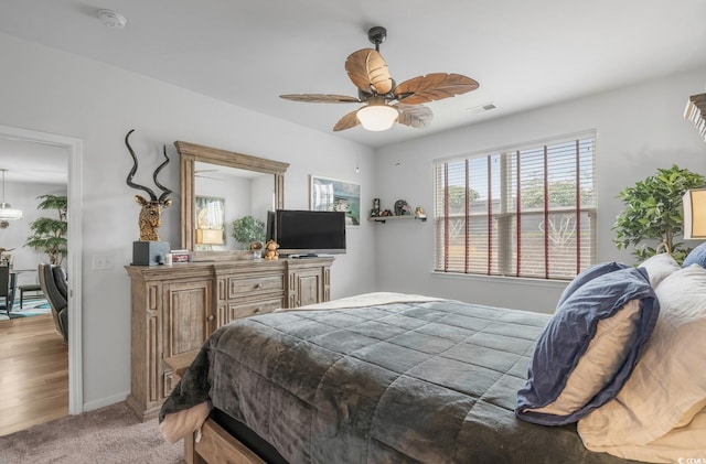 carpeted bedroom featuring visible vents and baseboards