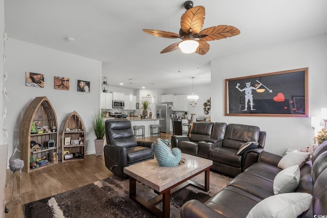 living room featuring ceiling fan and wood finished floors