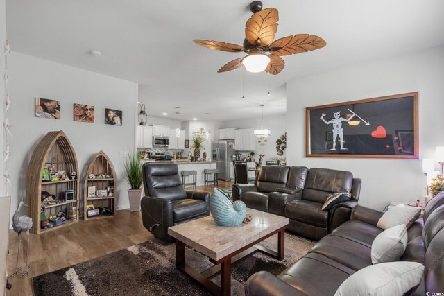 living room with recessed lighting, a ceiling fan, and wood finished floors