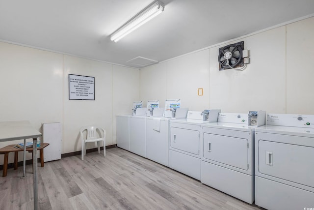 shared laundry area with light wood-type flooring and separate washer and dryer