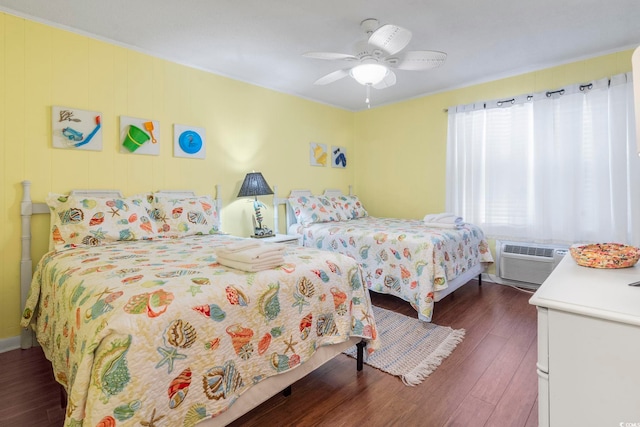 bedroom with hardwood / wood-style floors, ceiling fan, and a wall mounted air conditioner