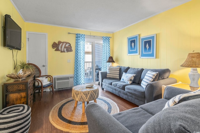 living room with a wall mounted air conditioner, crown molding, and wood finished floors