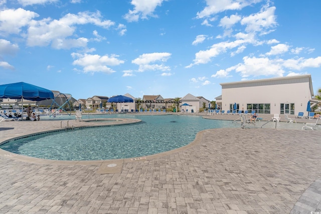 pool featuring a patio and a residential view