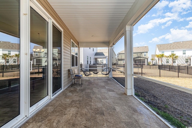 view of patio / terrace featuring a residential view and fence