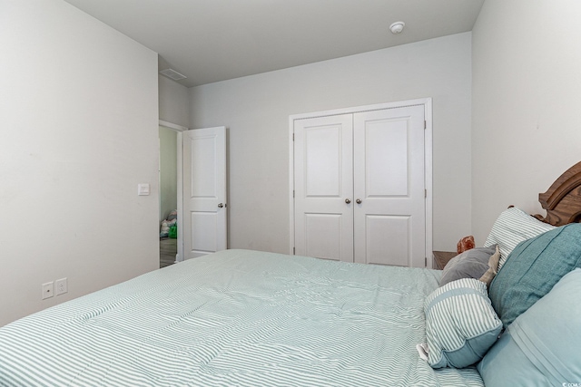 bedroom featuring a closet and visible vents