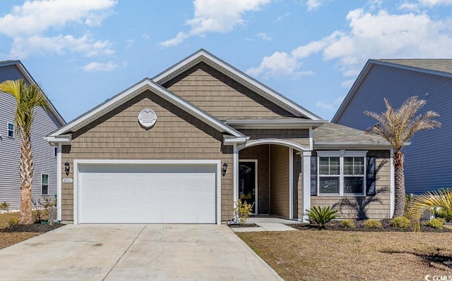 view of front of home with concrete driveway and an attached garage