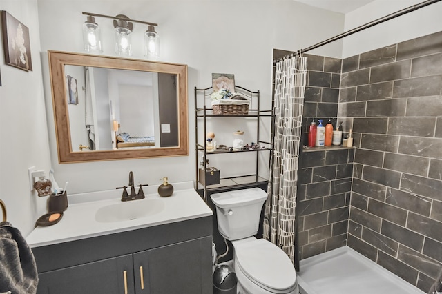 full bath with a shower stall, vanity, and toilet