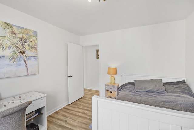 bedroom featuring baseboards and light wood-style floors