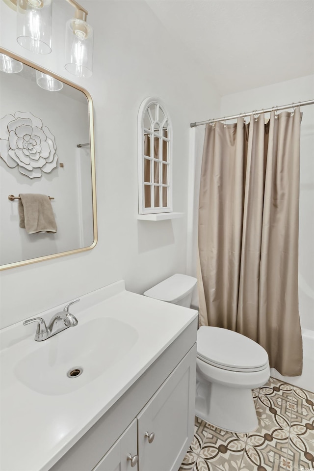 bathroom with vanity, tile patterned floors, toilet, and shower / tub combo with curtain