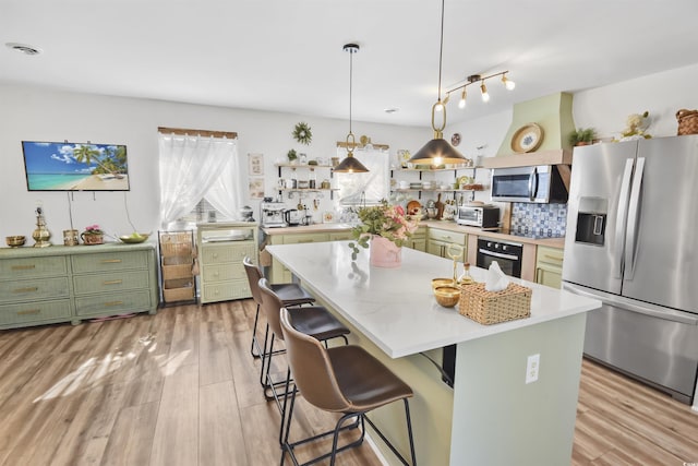 kitchen featuring open shelves, green cabinetry, appliances with stainless steel finishes, and light countertops